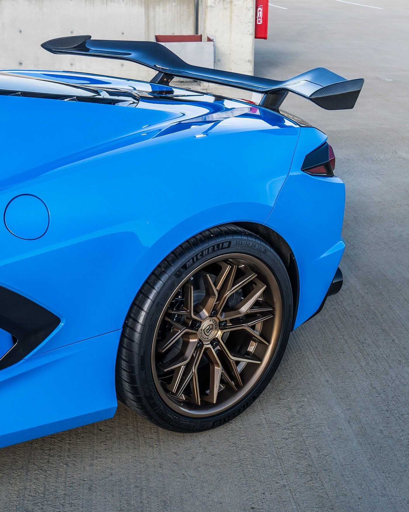 Rohana RFC3 Machine Bronze on a Blue C8 Corvette